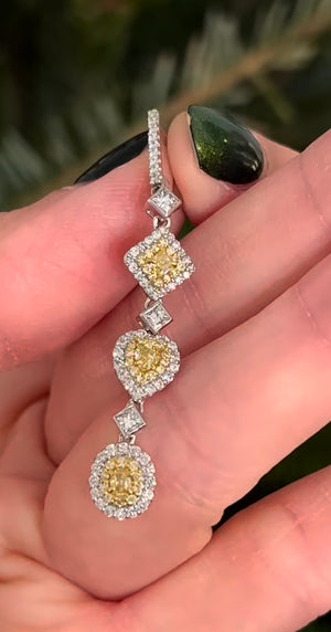 White gold latch back diamond earrings with princess cut, heart and oval yellow diamonds, princess cut white diamonds and round yellow and white diamonds natural