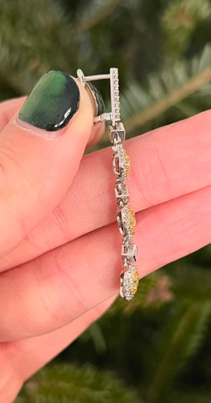 White gold latch back diamond earrings with princess cut, heart and oval yellow diamonds, princess cut white diamonds and round yellow and white diamonds natural