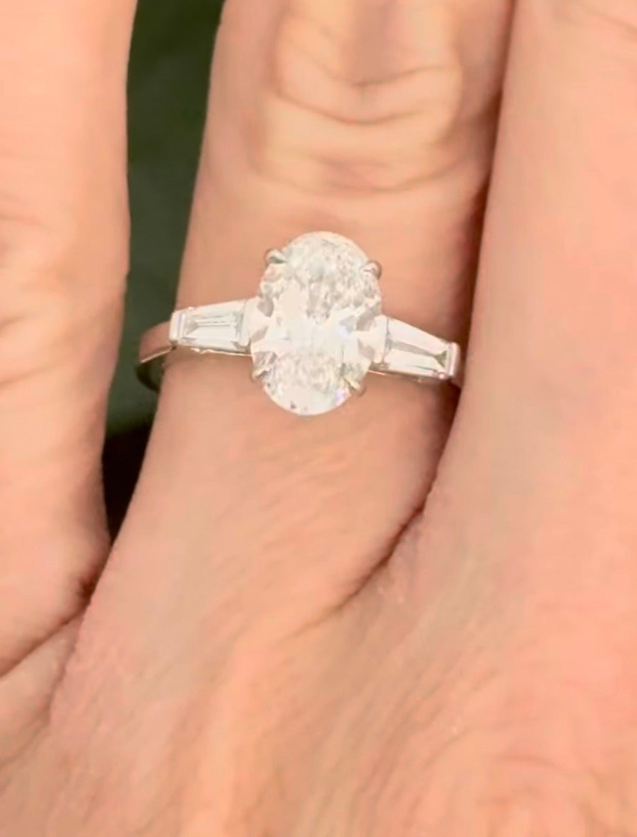 White gold IGI certified 2.02ct oval lab diamond and tapered baguette lab diamond ring. Oval measures 10.31x7.04x4.34mm