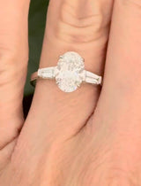 White gold IGI certified 2.02ct oval lab diamond and tapered baguette lab diamond ring. Oval measures 10.31x7.04x4.34mm