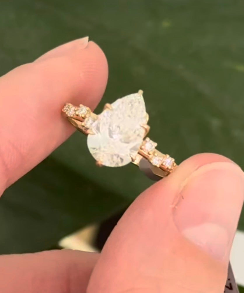 Yellow gold pear shape and round lab diamond ring