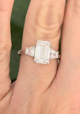 White gold IGI certified 3.04ct emerald cut lab diamond and trapezoid lab diamond ring. Emerald cut measures 10.12x6.70x4.46mm