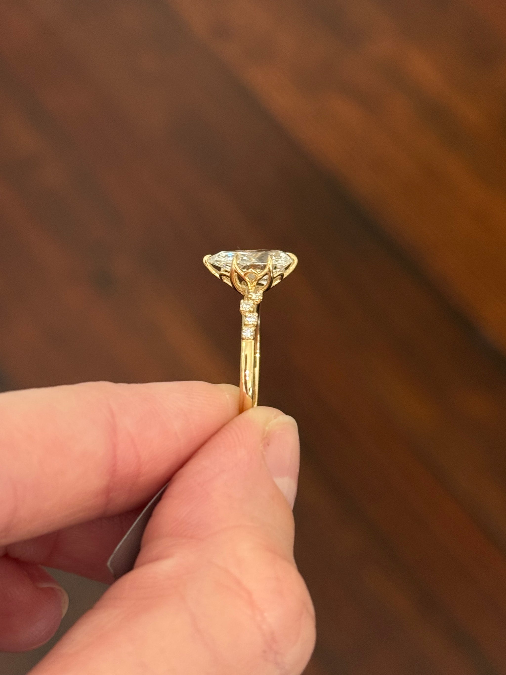 Yellow gold pear shape and round lab diamond ring