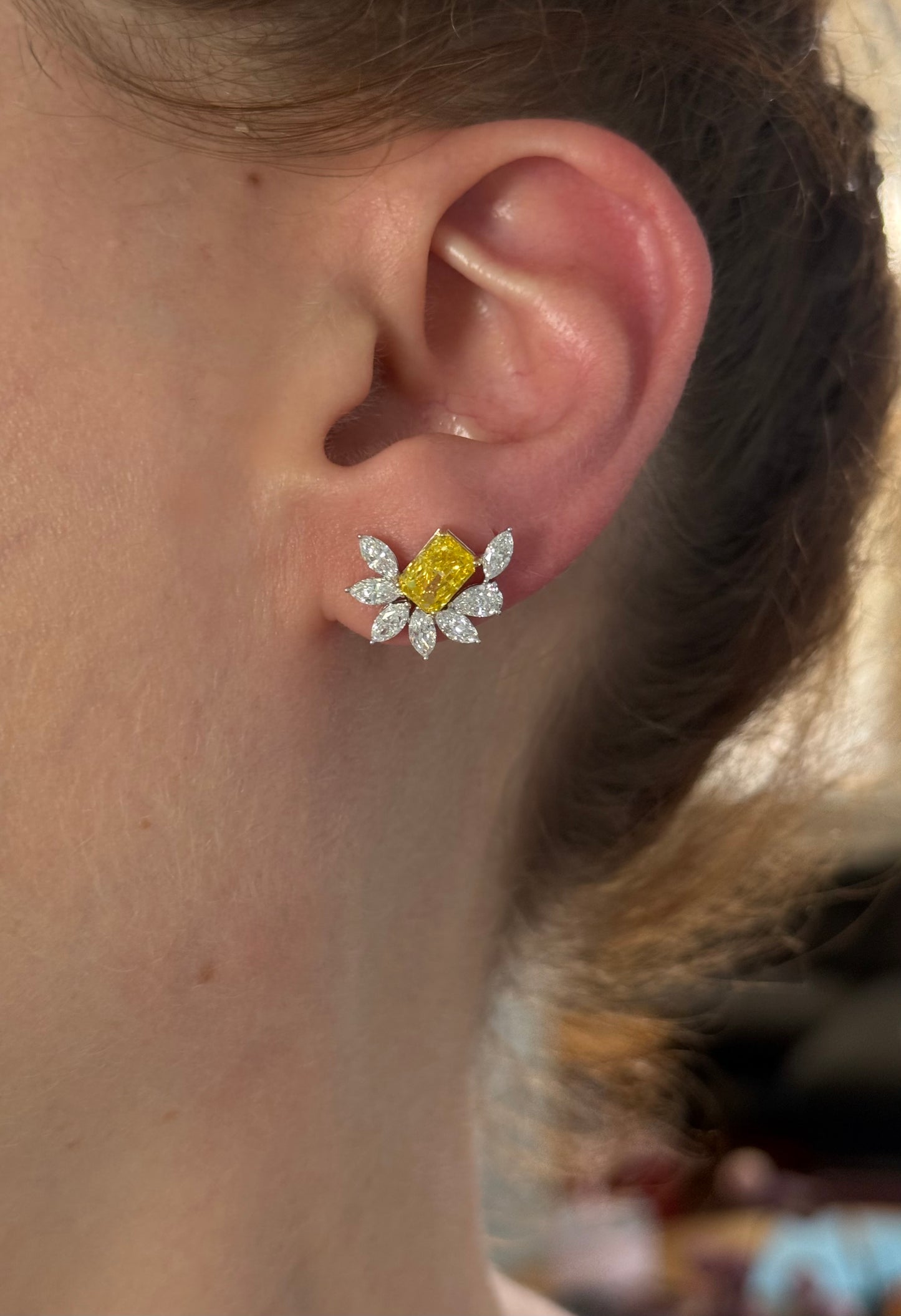 White gold radiant yellow lab diamond and pear shape and marquise white lab diamond earrings. Yellow lab diamond is set in yellow gold.