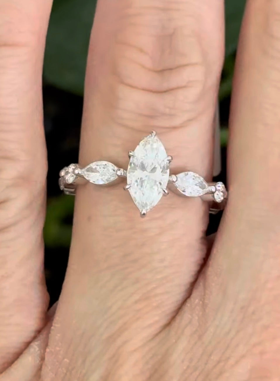 White gold marquise and round lab diamond ring. Center stone is 0.9cts and approximately 10x4.5mn