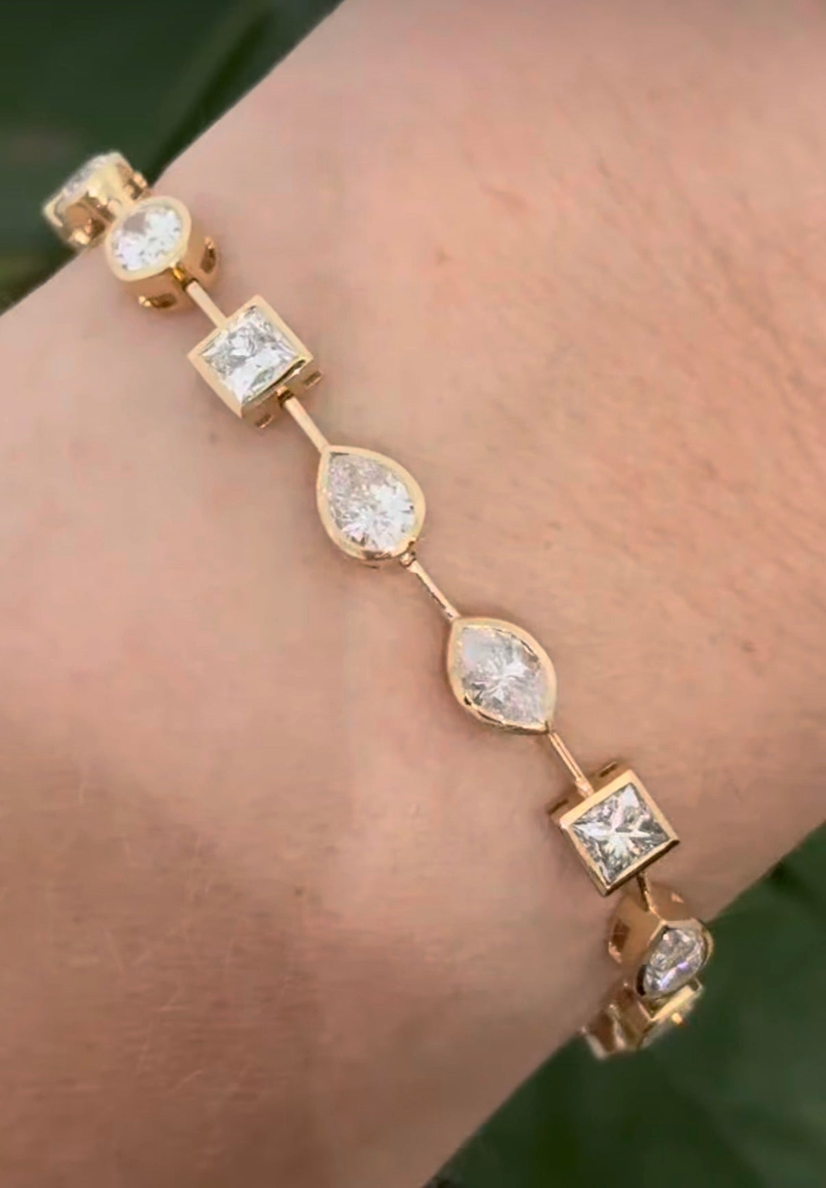 Yellow gold bezel set 7.44ct mixed shaped bracelet with oval, pear shape, marquise, princess and emerald cut natural diamonds