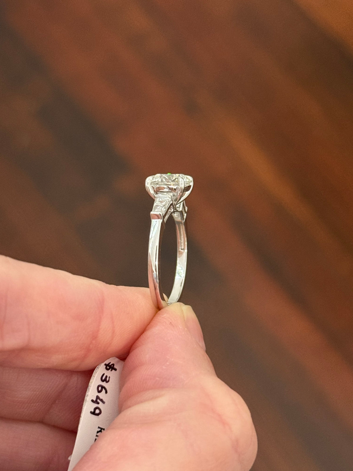 White gold IGI certified 2.04ct round lab diamond and tapered baguette lab diamond ring. Round measures 8.08x5.04mm