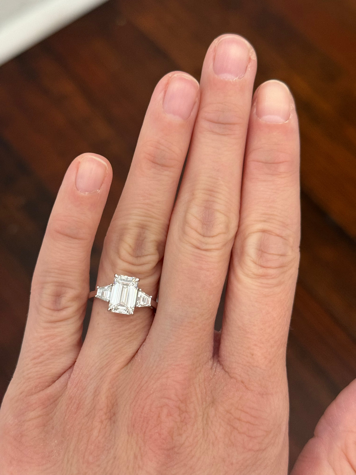 White gold IGI certified 3.04ct emerald cut lab diamond and trapezoid lab diamond ring. Emerald cut measures 10.12x6.70x4.46mm