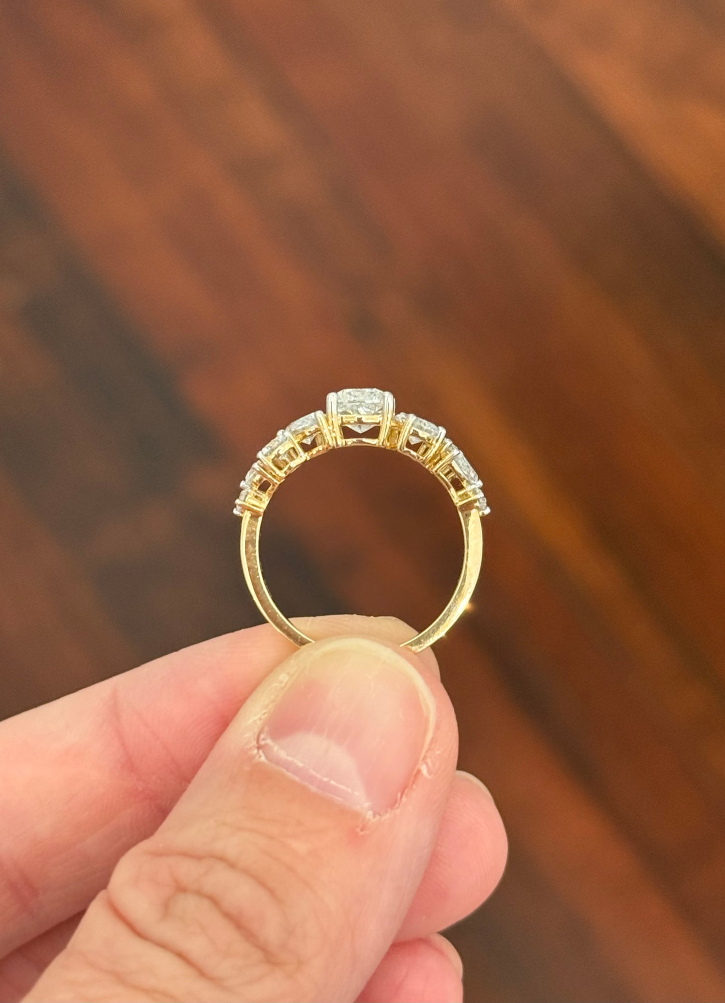 Yellow gold cushion, pear shape and round lab diamond ring. Prongs are white gold.