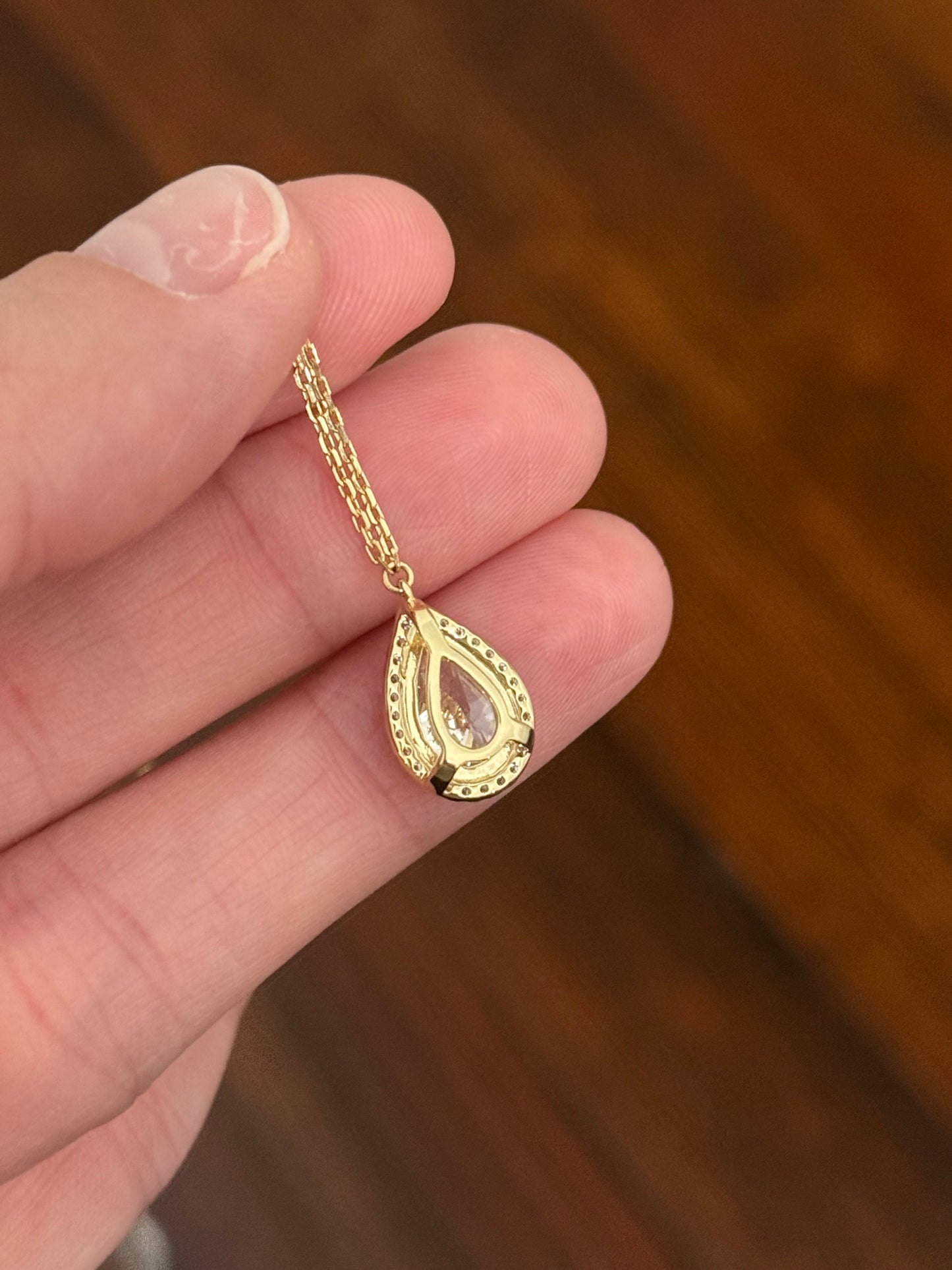 Yellow gold pear shaped lab diamond necklace. Center stone 2.07cts and measures 11x6.6mm. Chain is 16” with an adjustment of 4” to make as long as 20”.