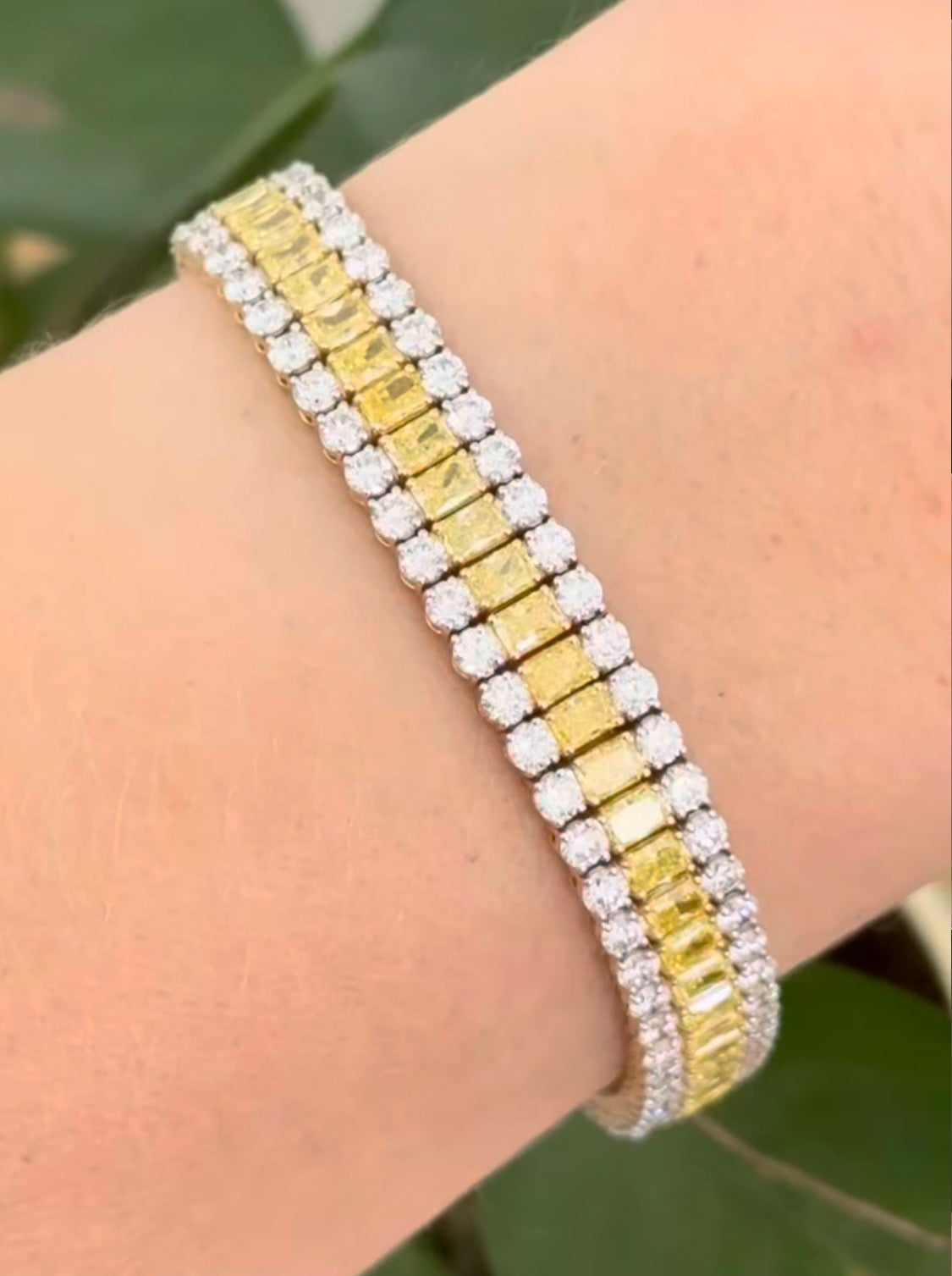 Yellow gold 17.44ct radiant yellow lab diamond and round white lab diamond bracelet. White diamond’s prongs are white gold.