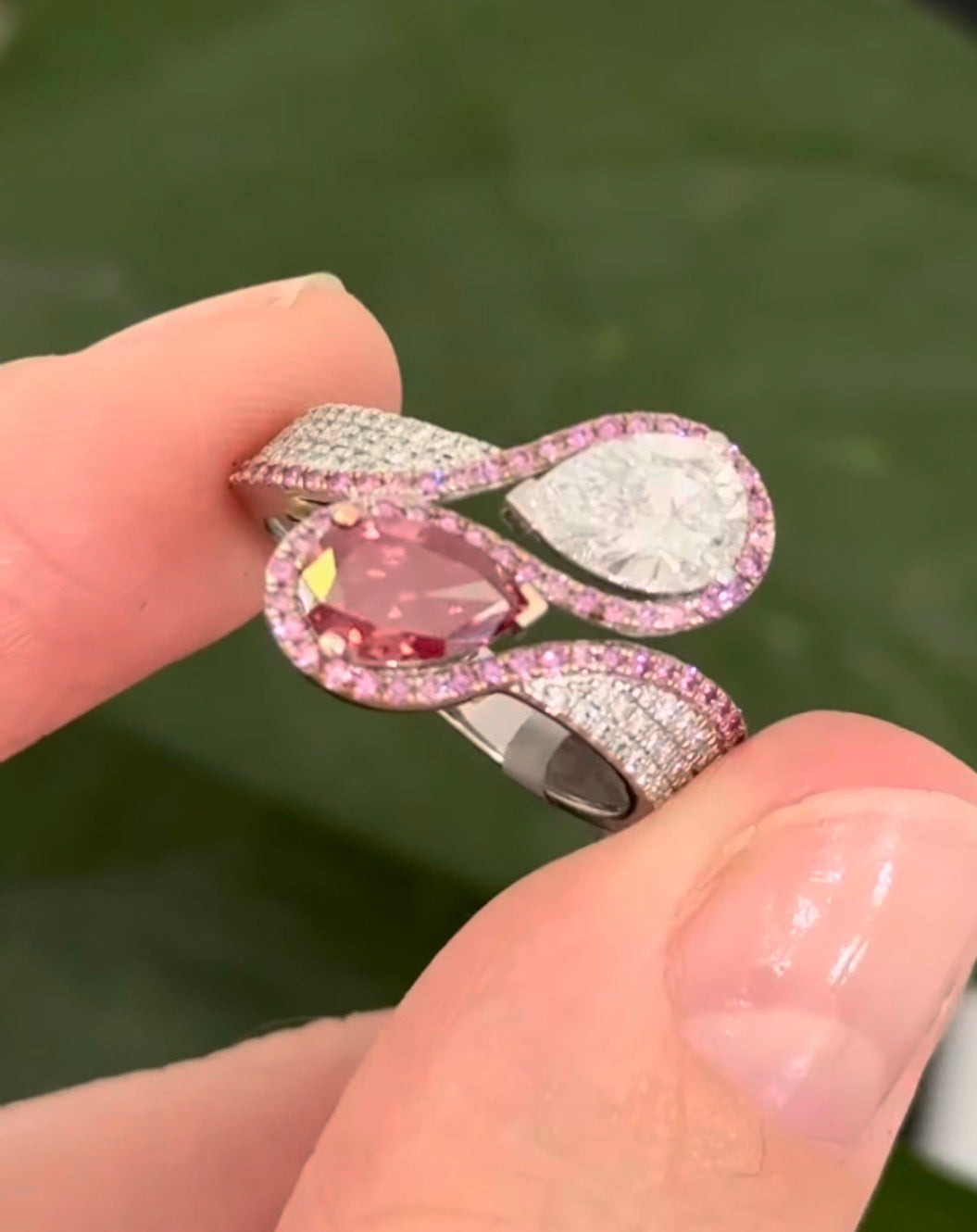 White gold pear shape and round pink and white lab diamond ring. Pink lab diamonds are set in rose gold.