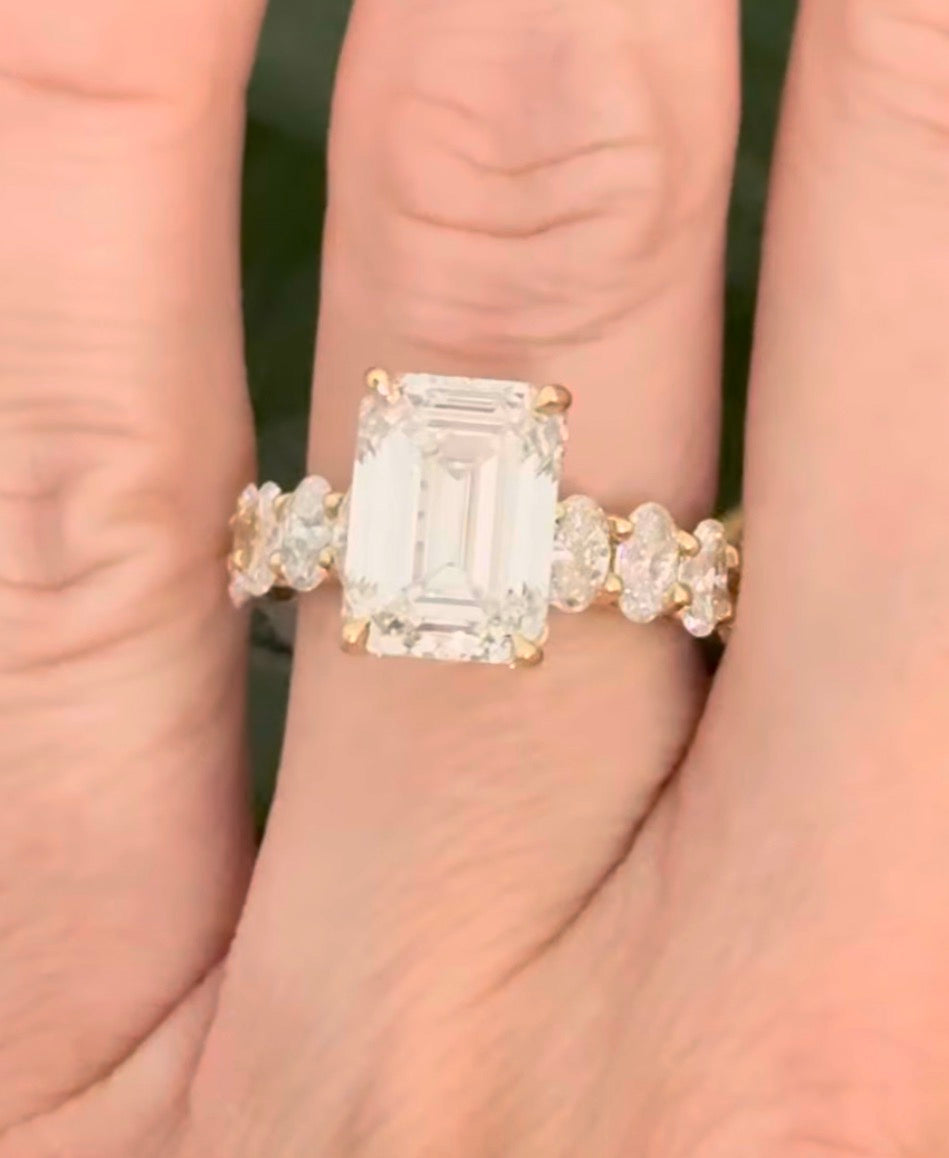 IGI certified emerald cut and oval and round lab diamond ring. Center stone is 5.05cts