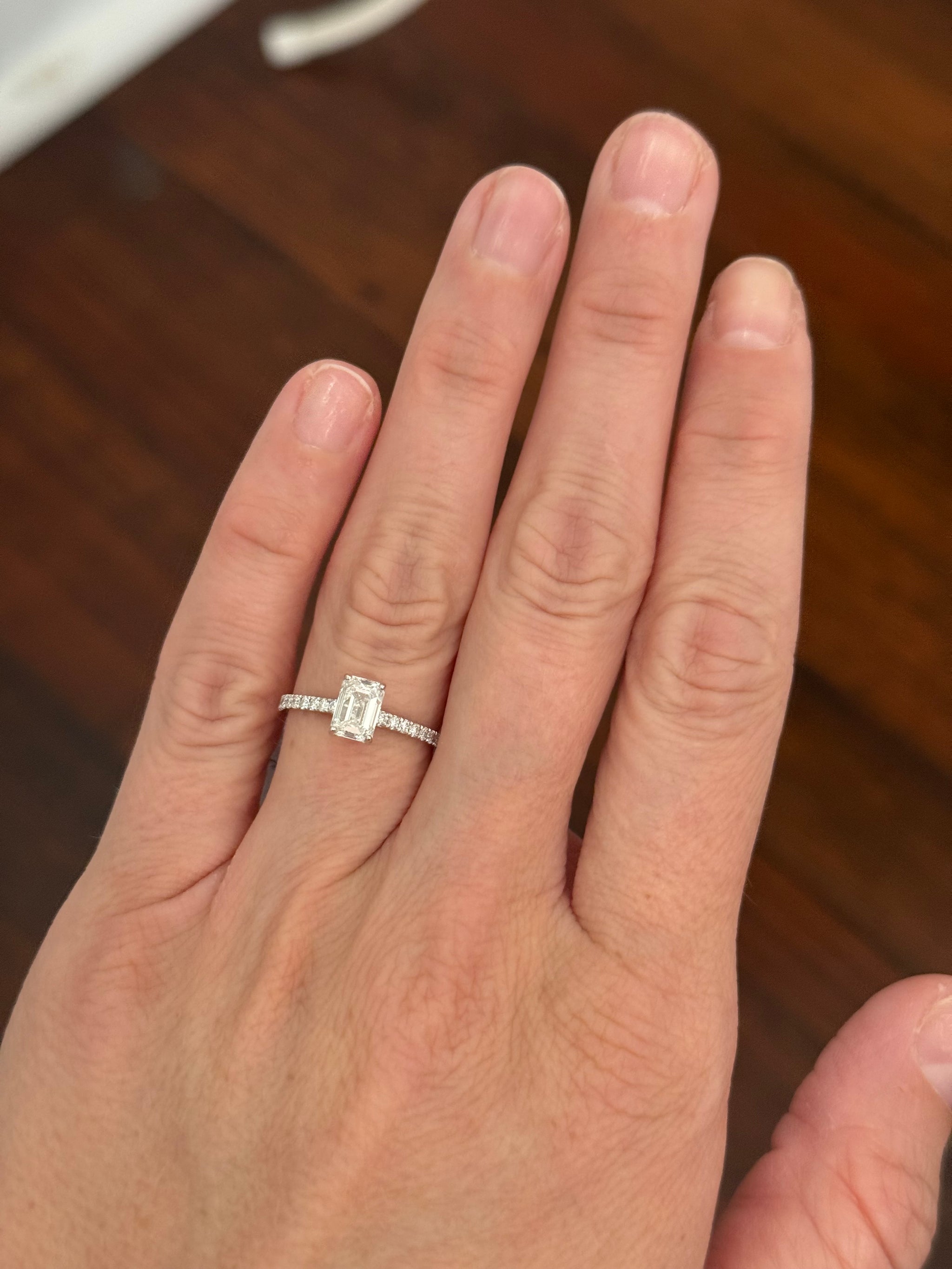White gold 1.35ct emerald cut lab diamond ring. Center stone is 1.09cts and measures 6.7x4.3mm