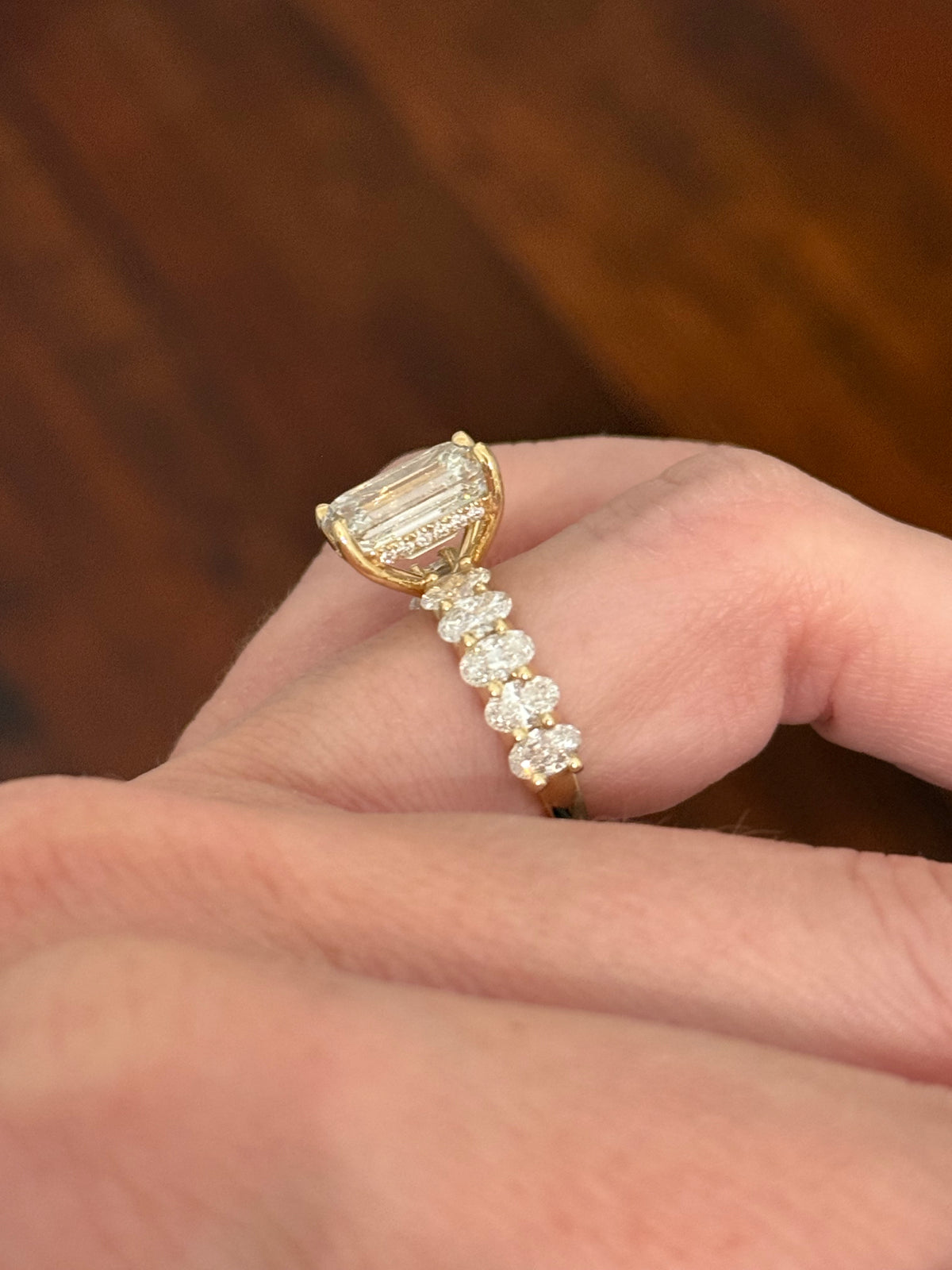 IGI certified emerald cut and oval and round lab diamond ring. Center stone is 5.05cts