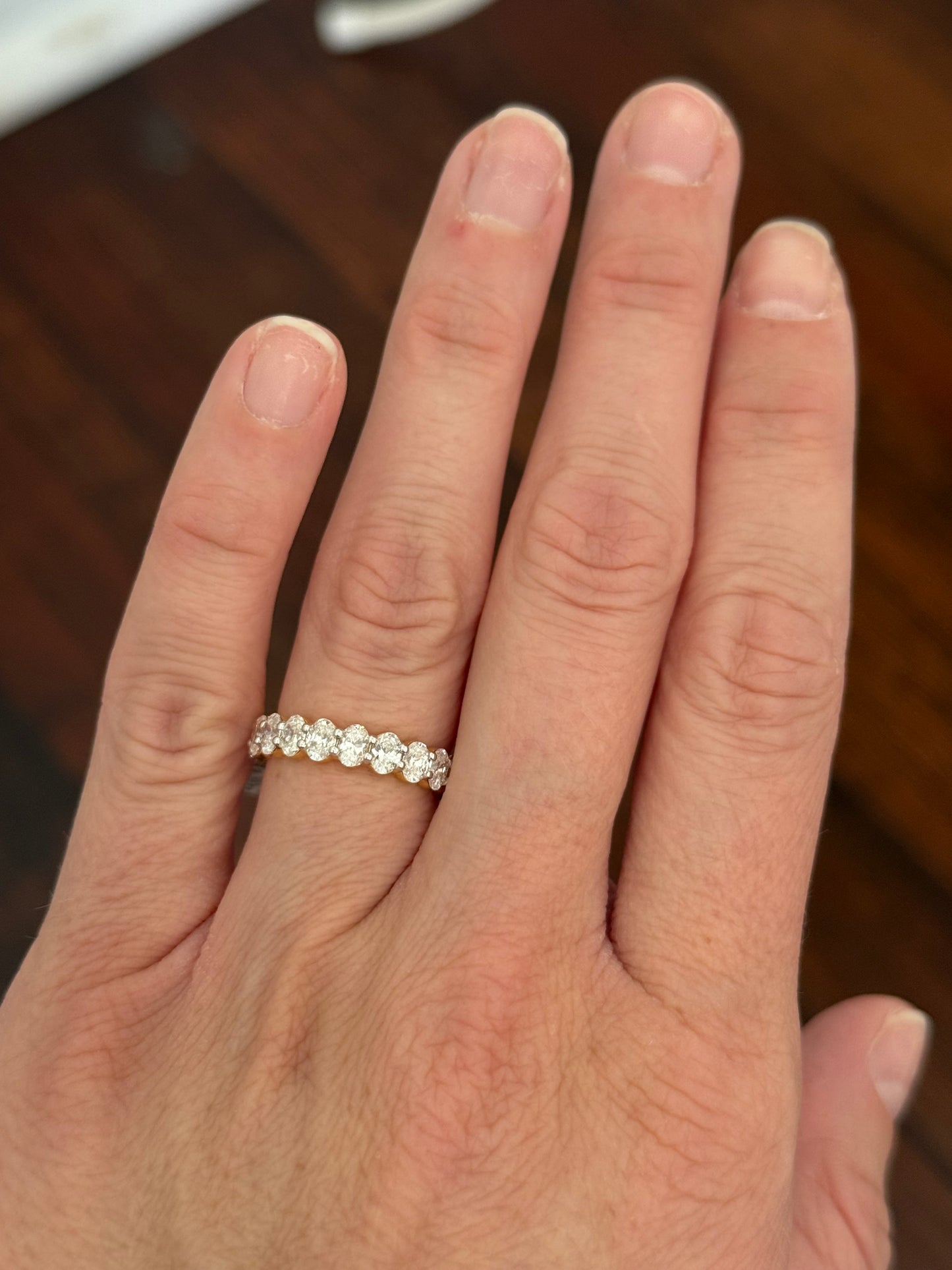 Yellow gold 3.02ct oval lab diamond eternity band. Prongs are white gold.