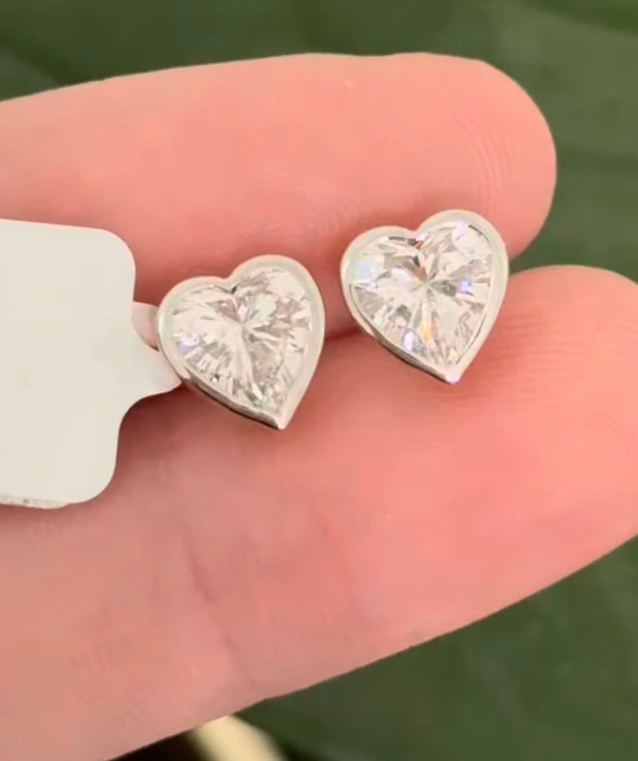 Yellow gold bezel set heart shape lab diamond stud earrings. Tops of bezel settings are white gold.