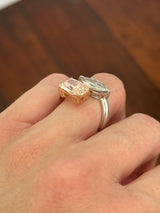 Rose and white gold cushion pink lab diamond and white marquise lab diamond toi et moi ring. Pink lab diamond is set in rose gold and white lab diamond is set in white gold.