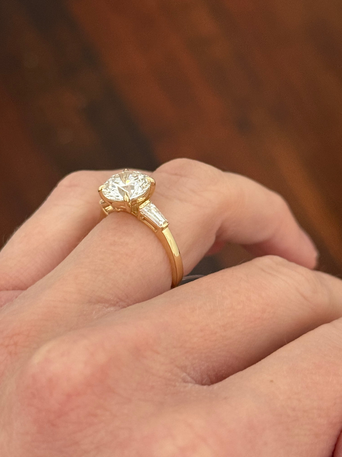 Yellow gold IGI certified 3.0ct round lab diamond and tapered baguette lab diamond ring. Round measures 9.18x5.71mm