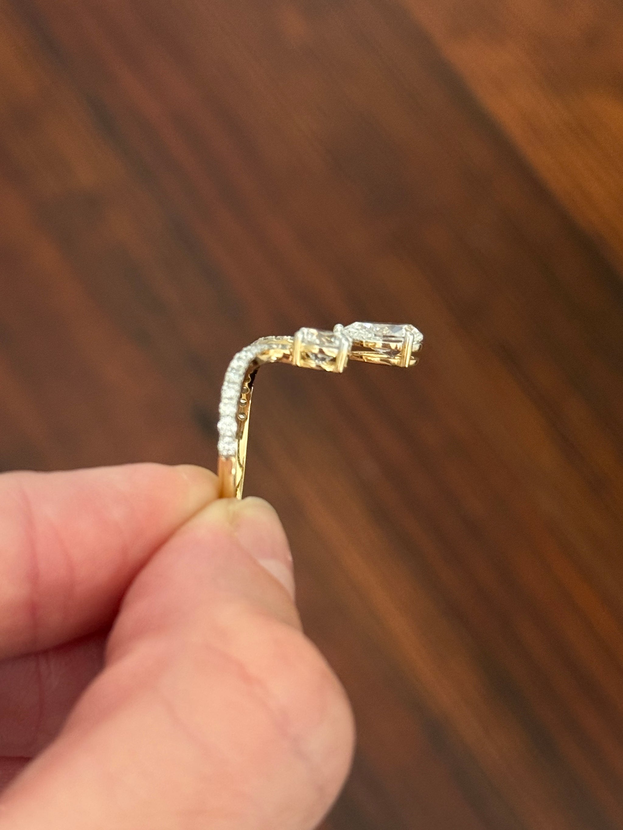 Yellow gold pear shape and round lab diamond ring. Prongs are white gold.