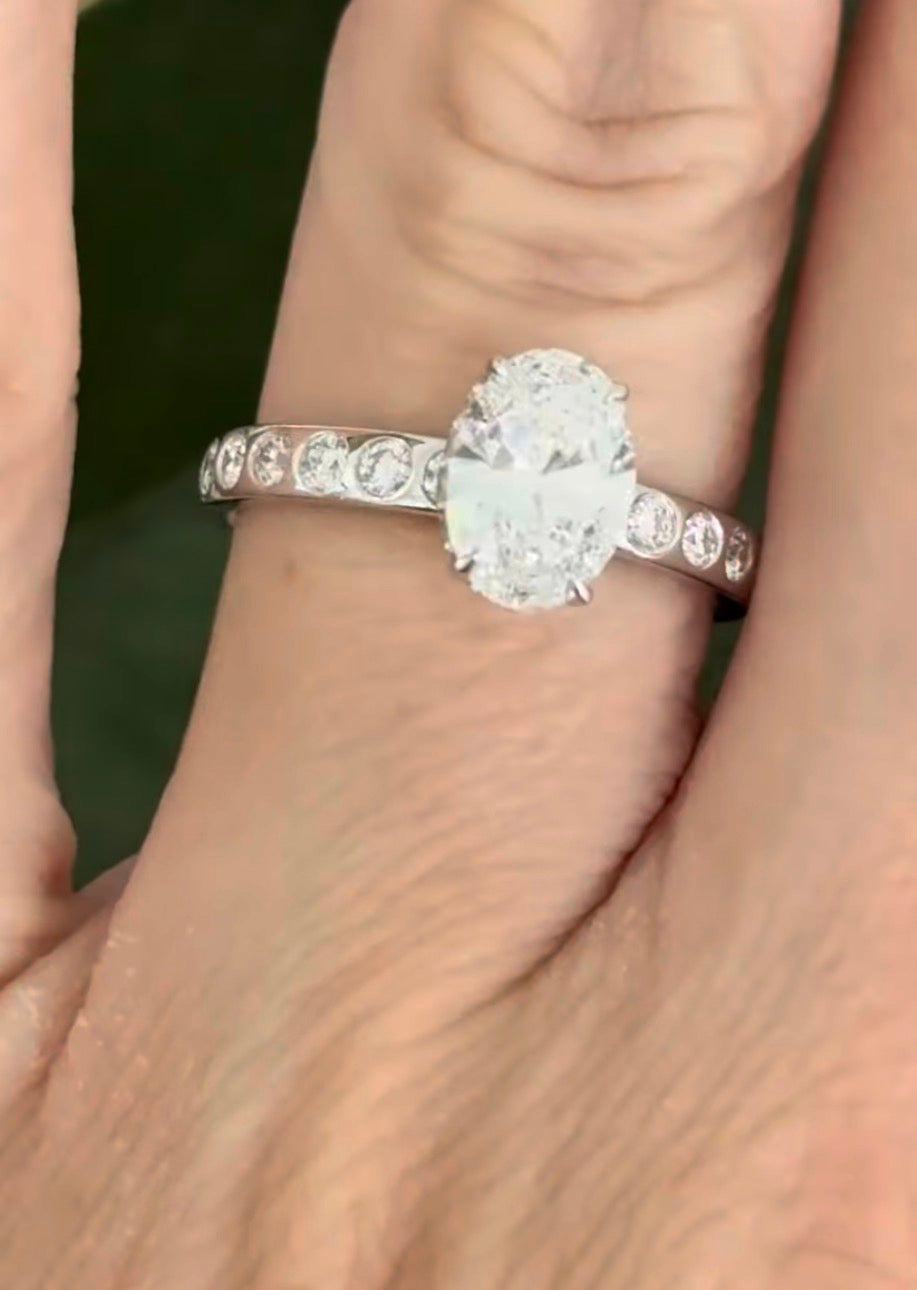 White gold oval and round lab diamond ring. Center stone is 1ct and 8.5x6mm