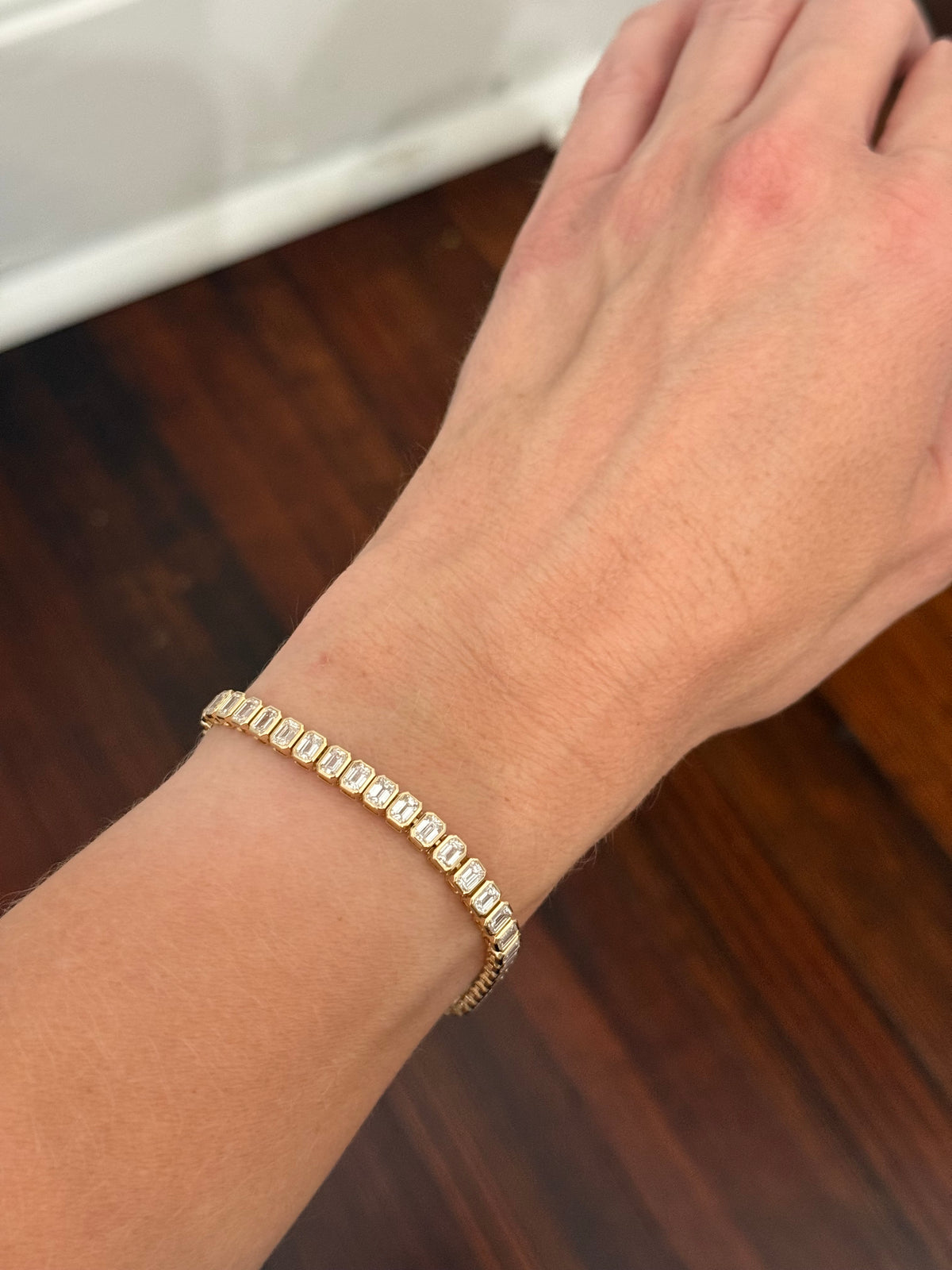 Yellow gold bezel set 10.07ct emerald cut lab diamond bracelet