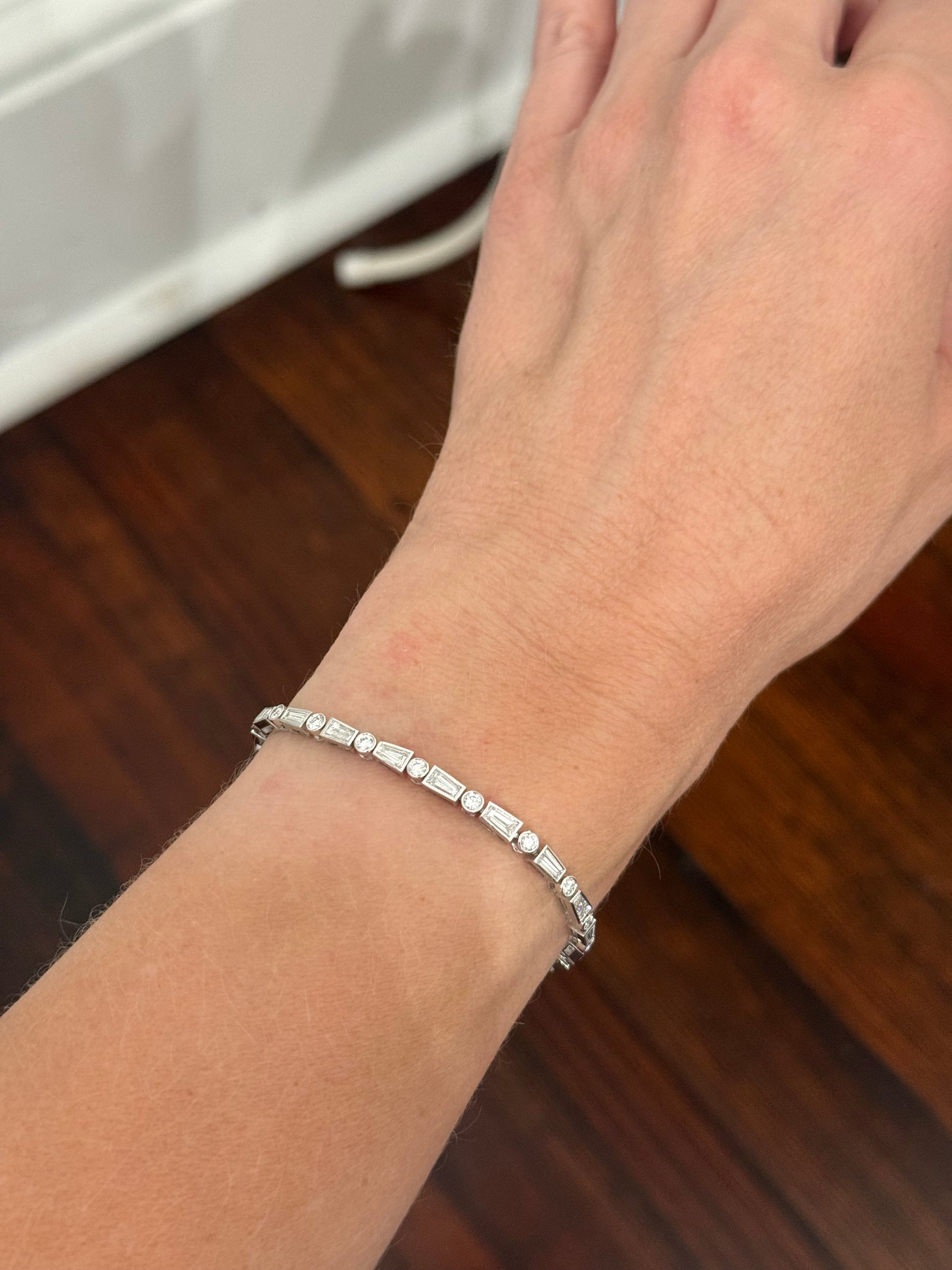 White gold bezel set 4.22ct tapered baguette and round natural diamond bracelet