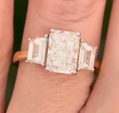 Yellow gold radiant and trapezoid lab diamond ring. Prongs are white gold.