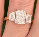 Yellow gold radiant and trapezoid lab diamond ring. Prongs are white gold.