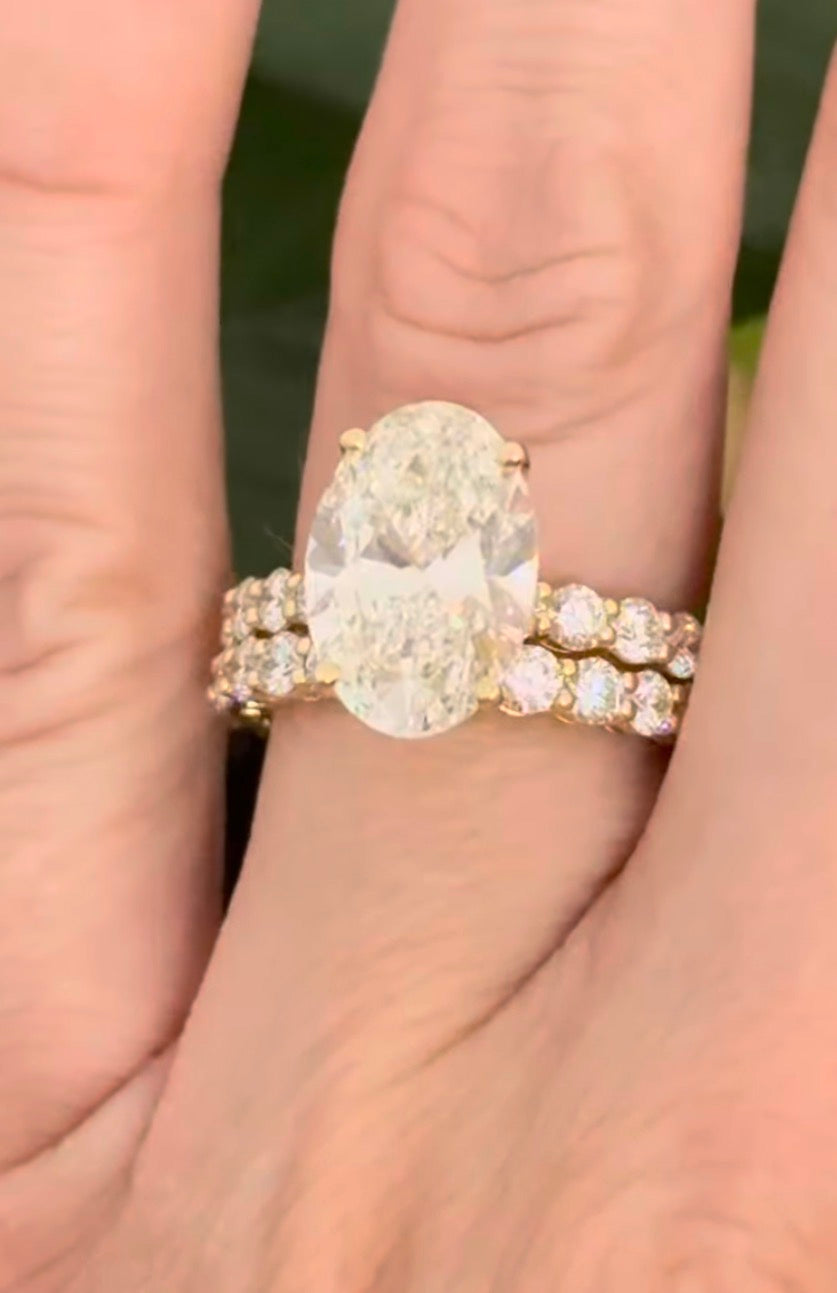 Yellow gold oval and round lab diamond ring and band set. Center stone is 5.1cts