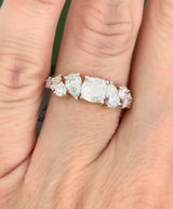 Yellow gold cushion, pear shape and round lab diamond ring. Prongs are white gold.