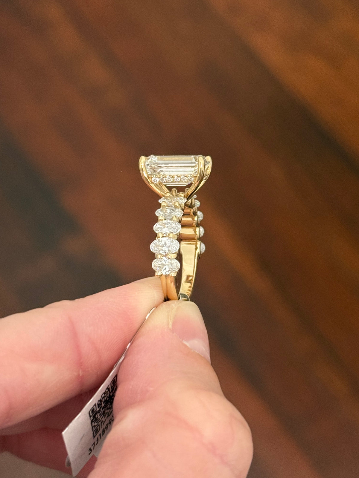 IGI certified emerald cut and oval and round lab diamond ring. Center stone is 5.05cts