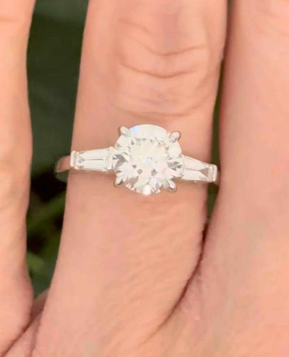 White gold IGI certified 2.04ct round lab diamond and tapered baguette lab diamond ring. Round measures 8.08x5.04mm