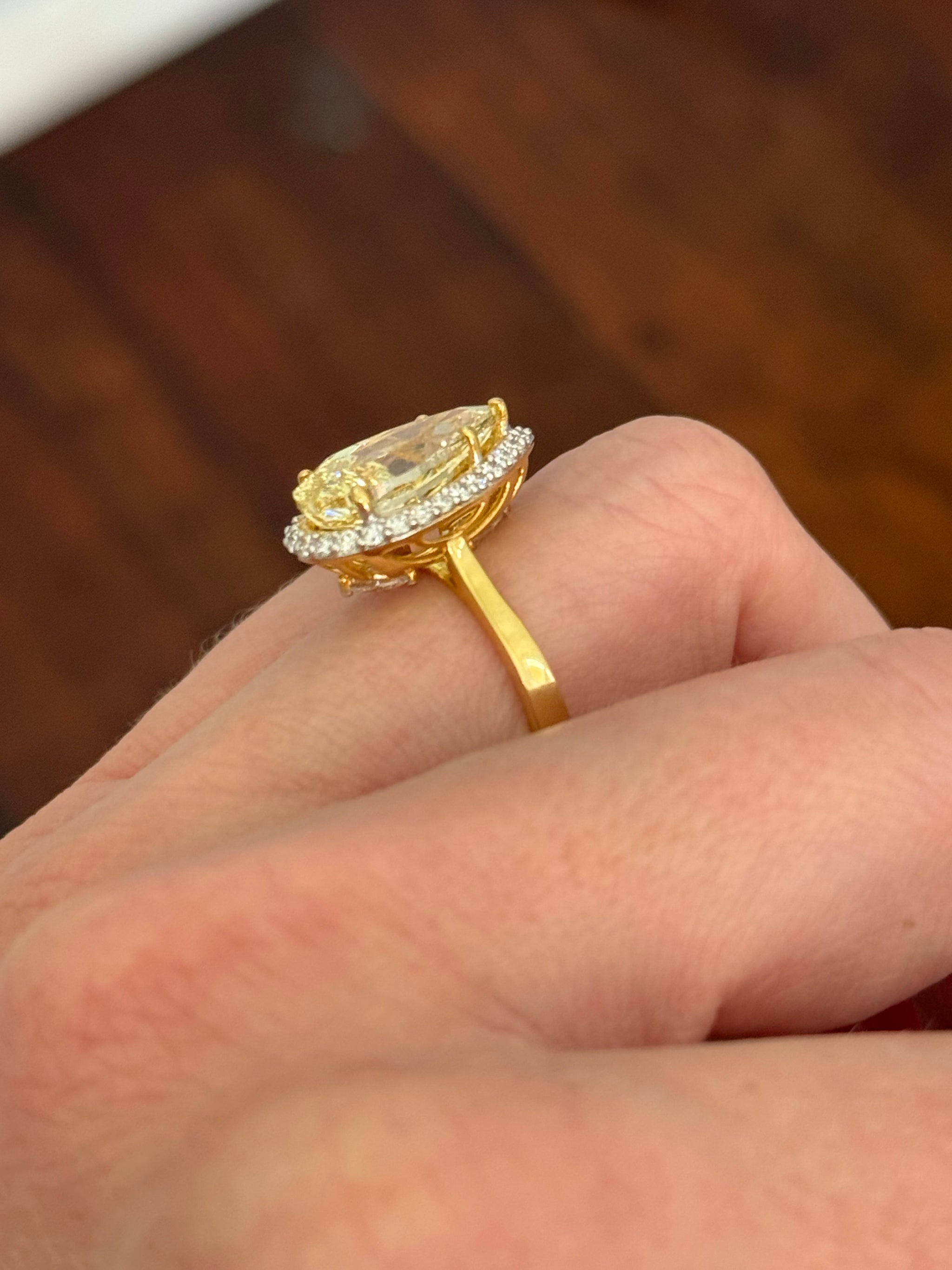 Yellow gold pear shape yellow lab diamond and white lab diamond ring