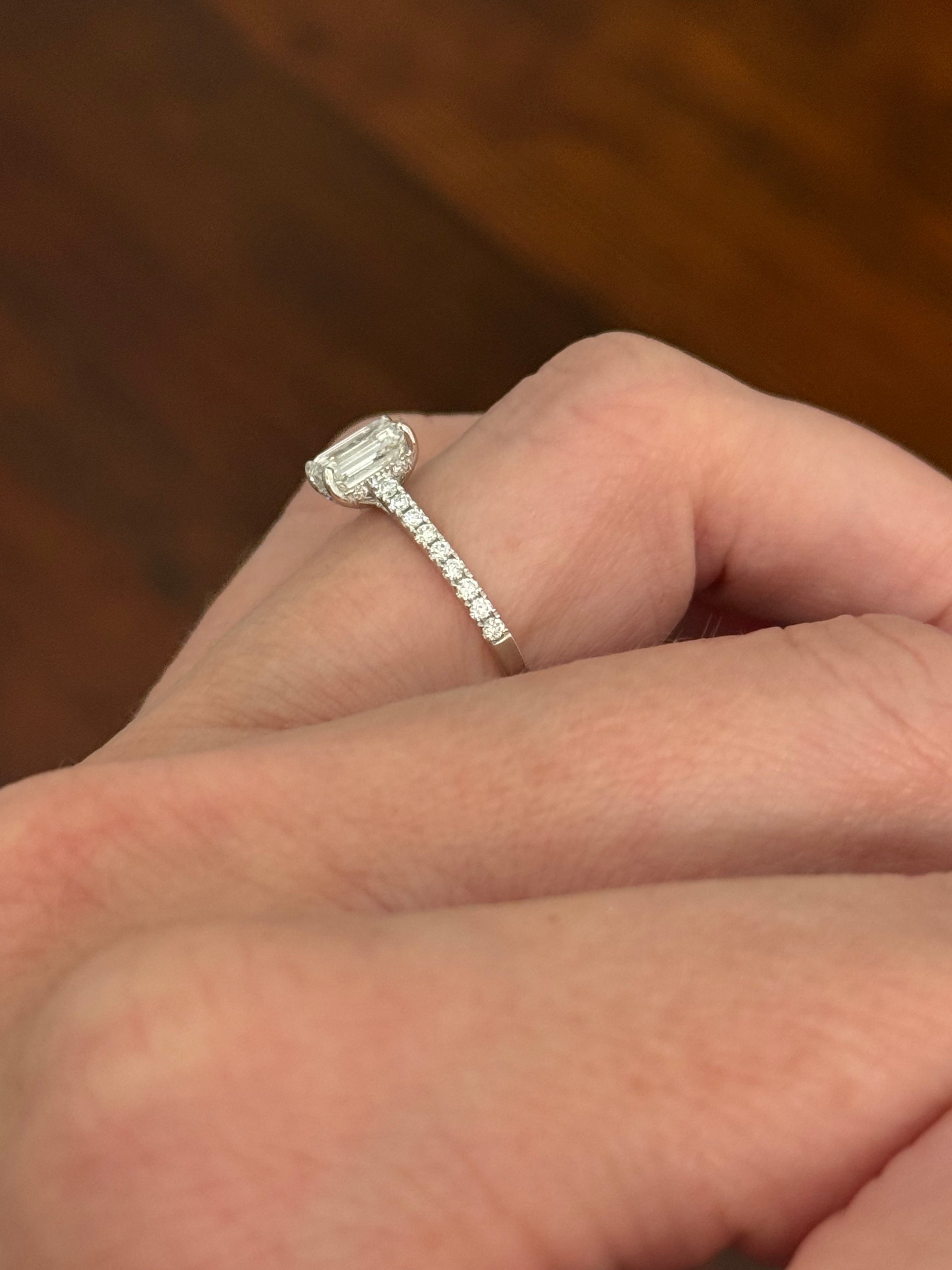 White gold 1.35ct emerald cut lab diamond ring. Center stone is 1.09cts and measures 6.7x4.3mm