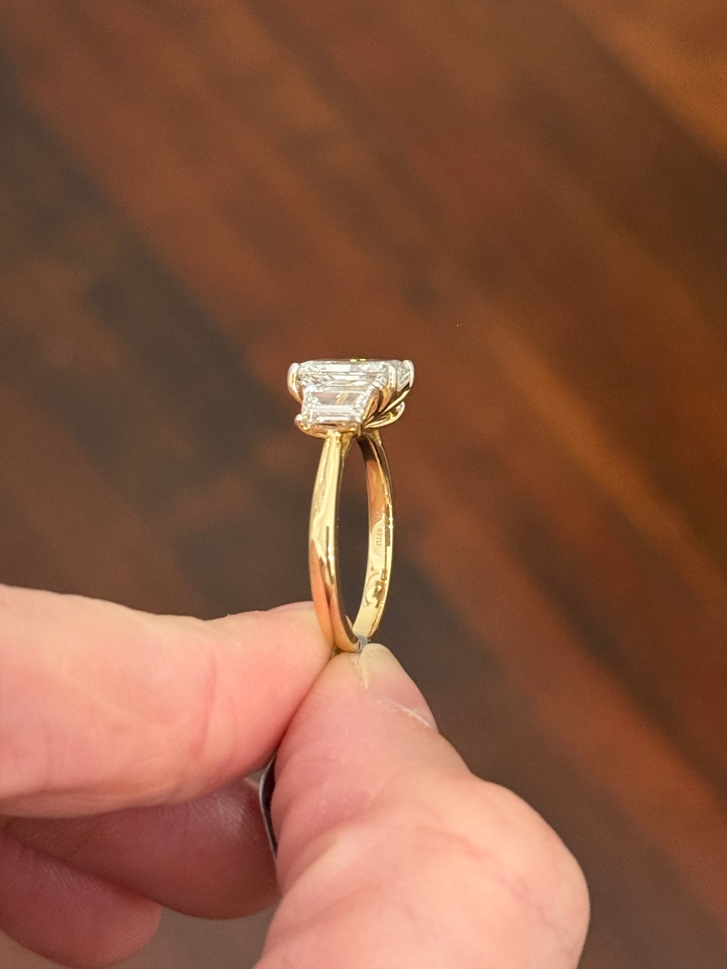 Yellow gold radiant and trapezoid lab diamond ring. Prongs are white gold.
