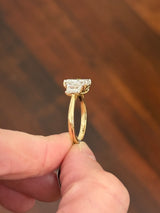 Yellow gold radiant and trapezoid lab diamond ring. Prongs are white gold.