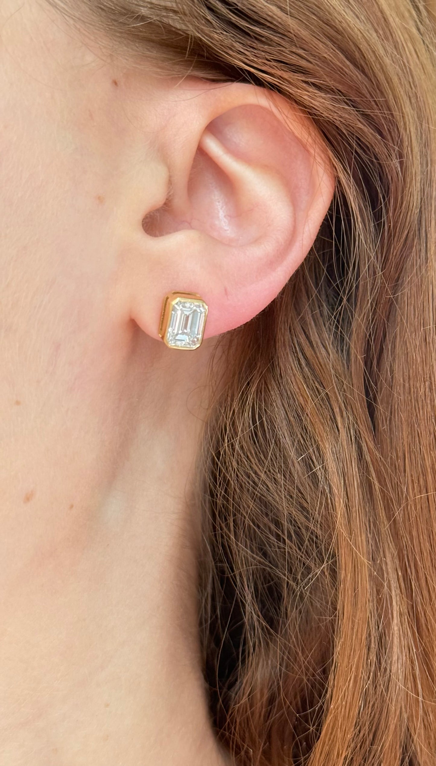 Yellow gold bezel set IGI certified 2+2ct emerald cut lab diamond stud earrings with screw backs