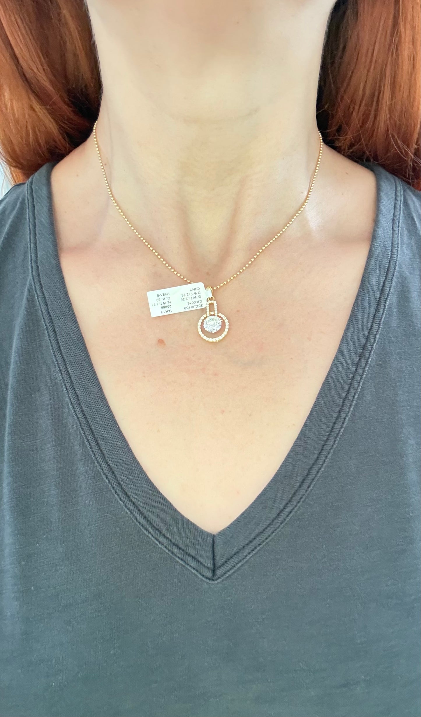 Yellow gold lab diamond pendant. Center stone is 8.0mm and set in white gold