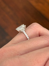 White gold emerald cut, trapezoid, and round lab diamond ring. Center stone is 4.06cts
