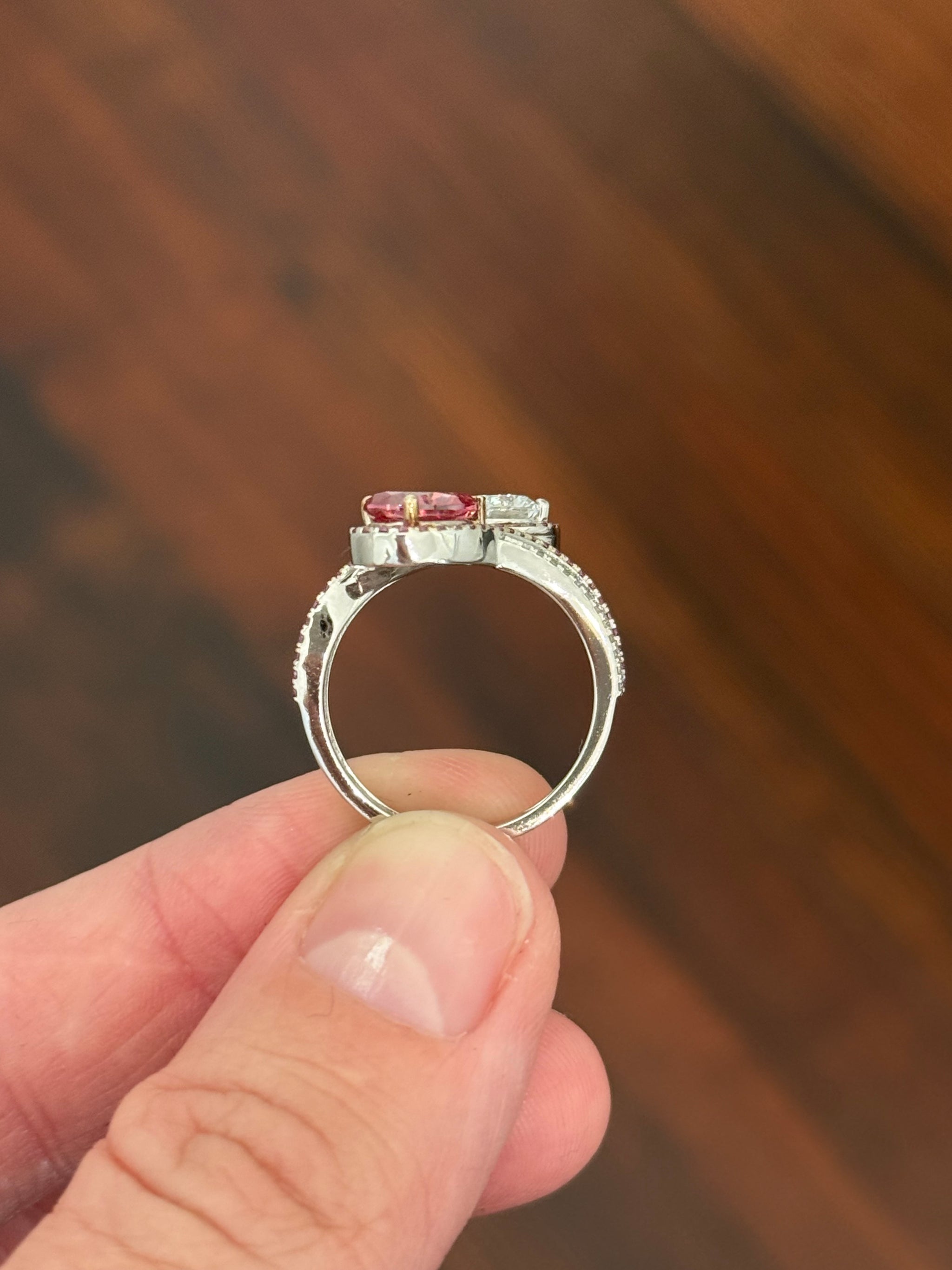 White gold pear shape and round pink and white lab diamond ring. Pink lab diamonds are set in rose gold.