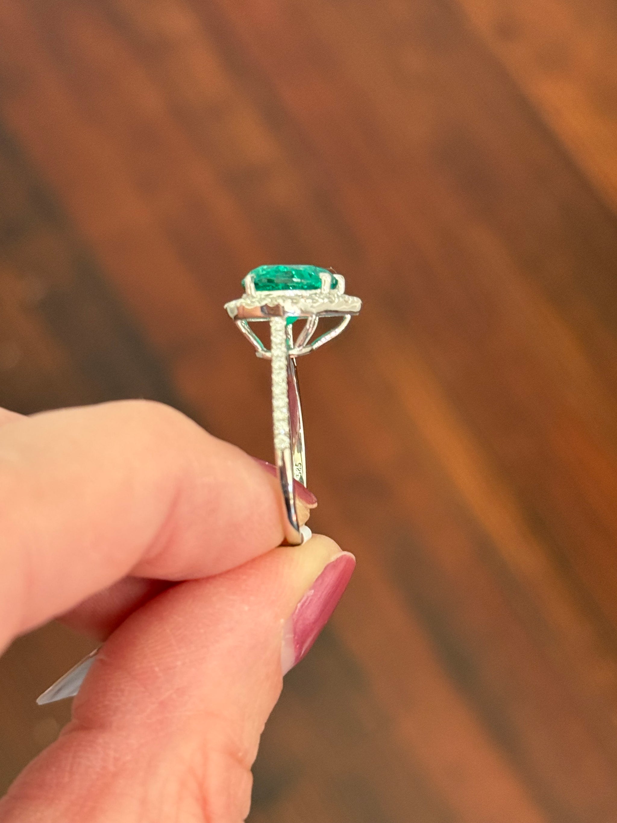 White gold heart shape lab emerald and round lab diamond ring
