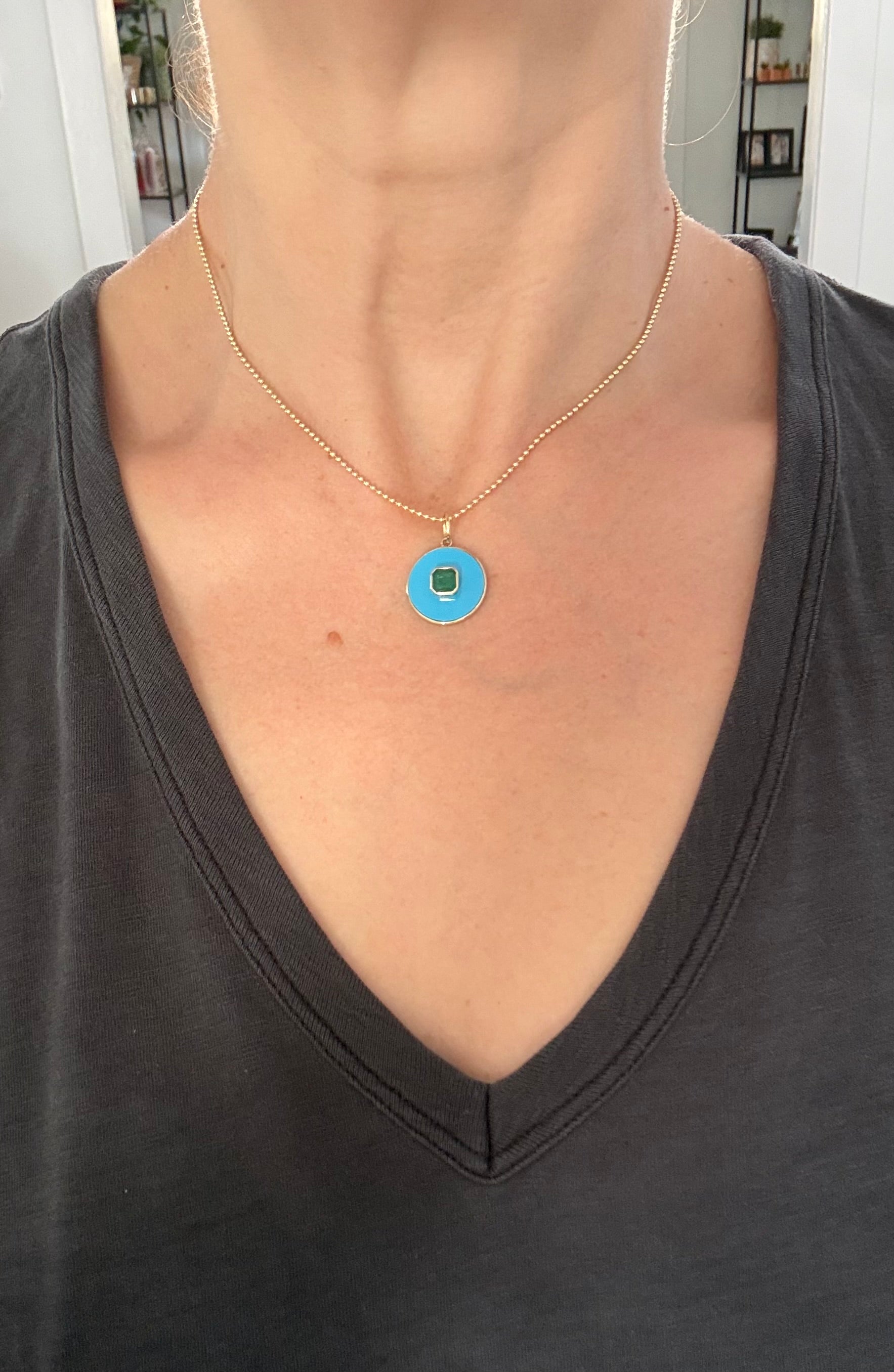 Yellow gold emerald pendant
