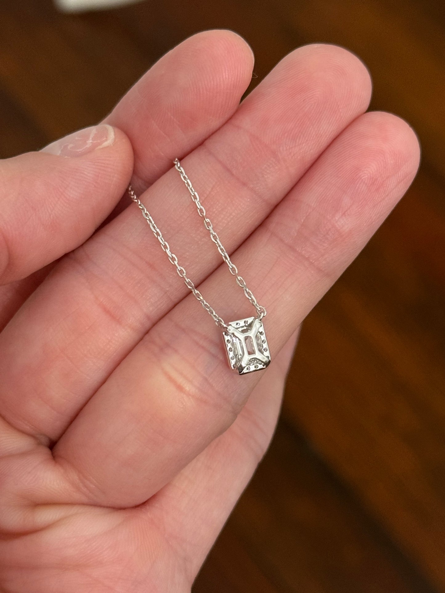 White gold emerald cut lab diamond necklace. Center stone is 0.50cts and measures 5.2x3.7mm. Chain is 16” with an adjustment of 4” to make as long as 20”.