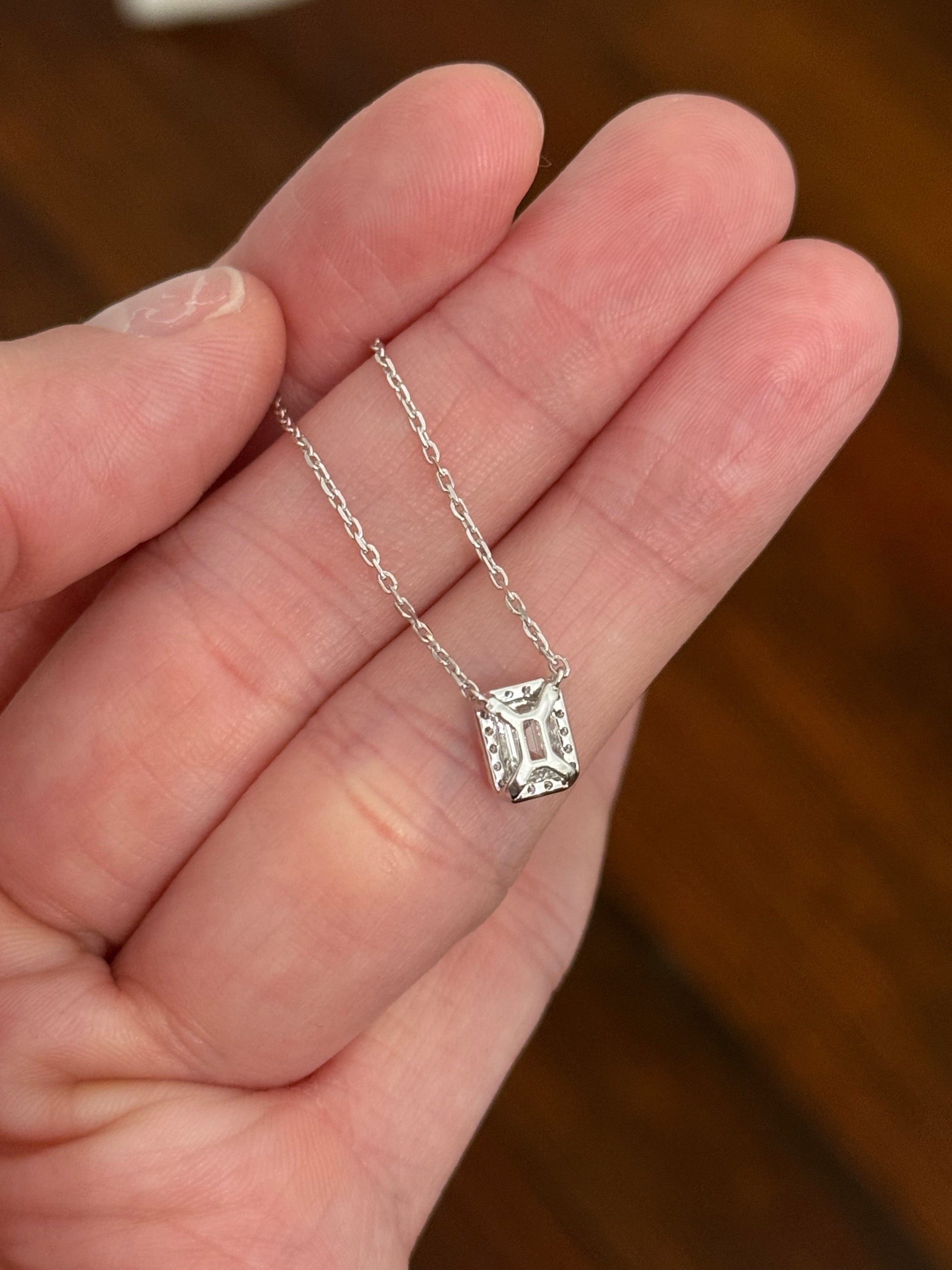 White gold emerald cut lab diamond necklace. Center stone is 0.50cts and measures 5.2x3.7mm. Chain is 16” with an adjustment of 4” to make as long as 20”.