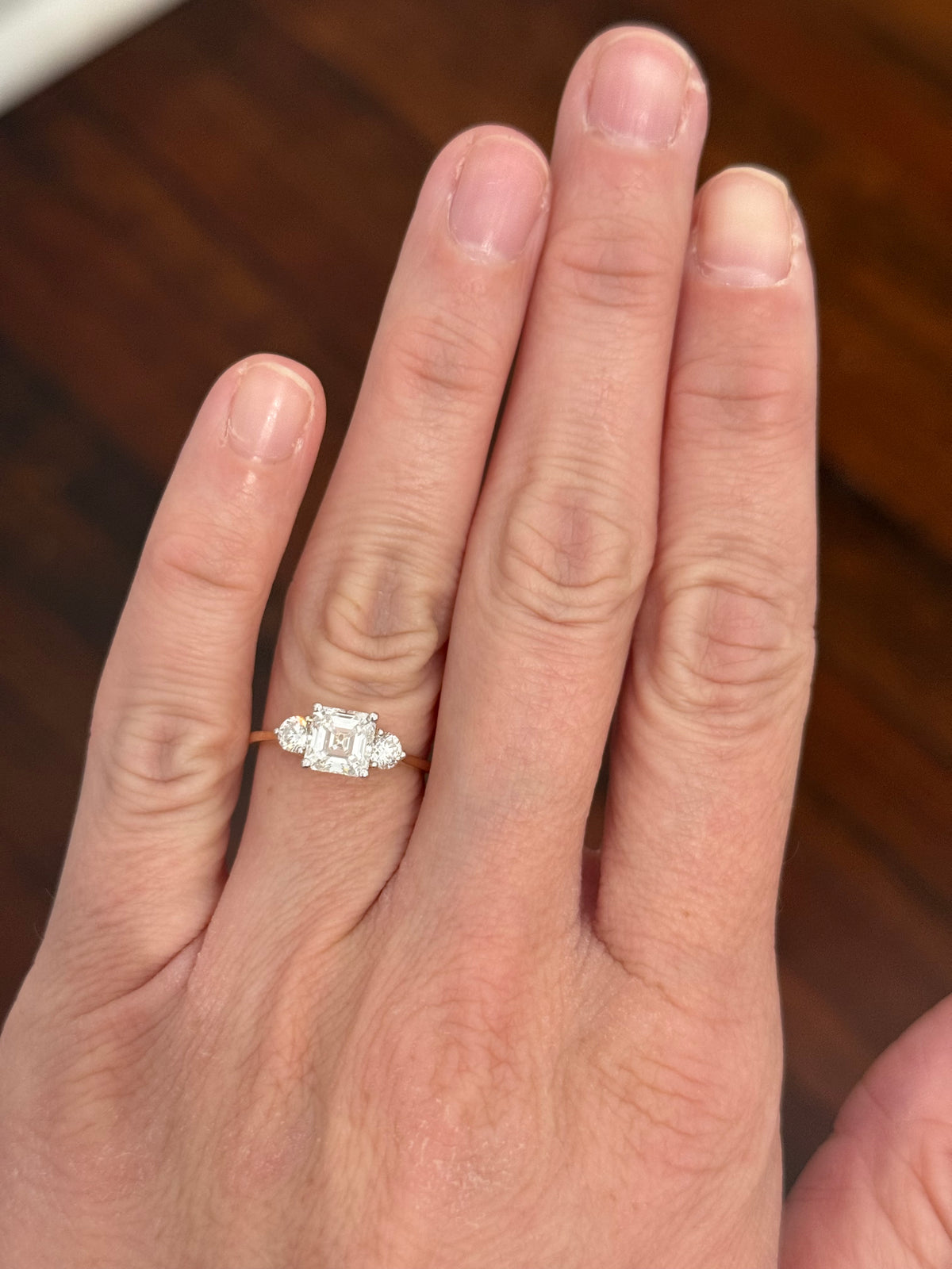 Yellow gold asscher and round lab diamond ring. Prongs are white gold.