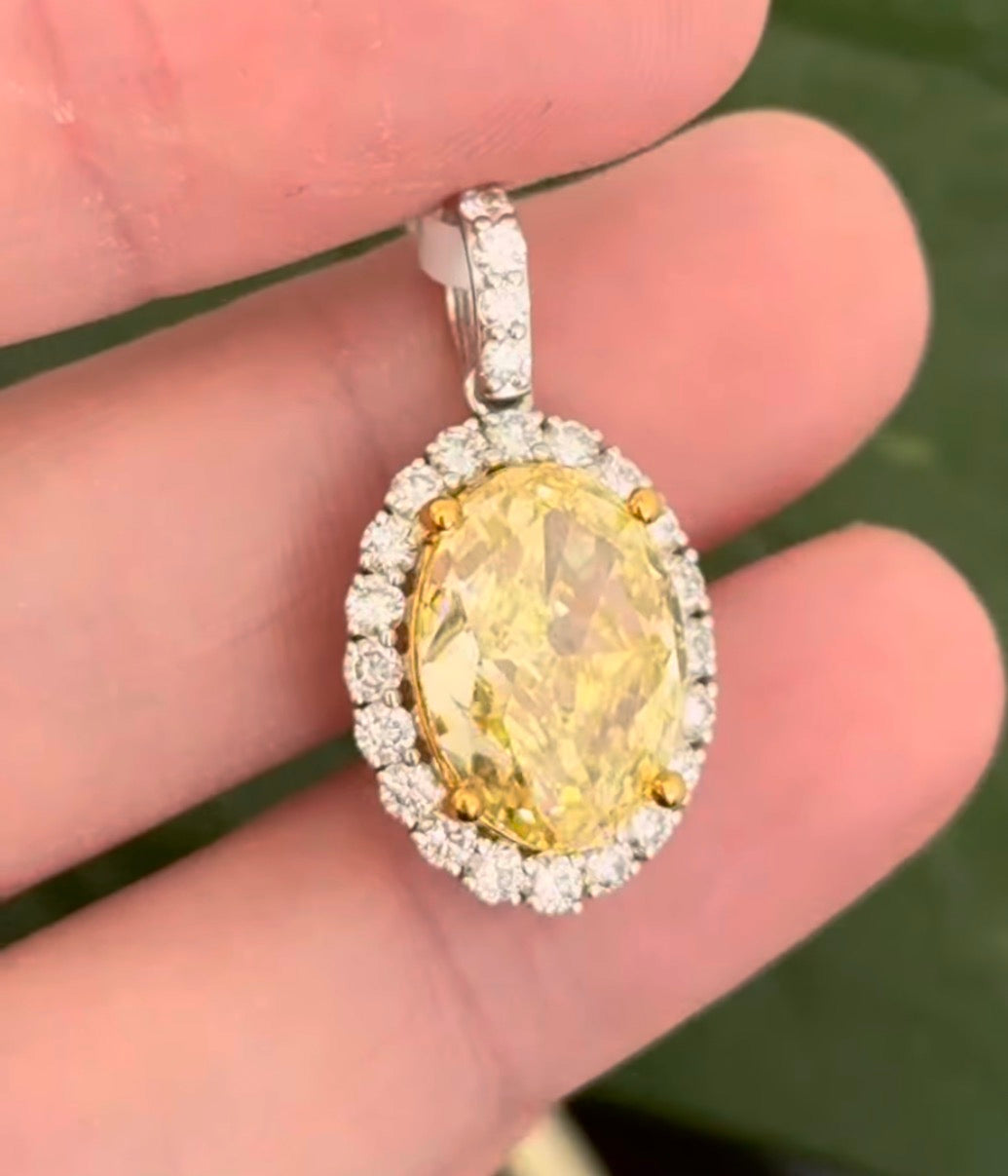 White gold oval yellow lab diamond and white round lab diamond pendant. Yellow lab diamond has yellow gold prongs and is IGI certified 5.11cts fancy vivid yellow VS2