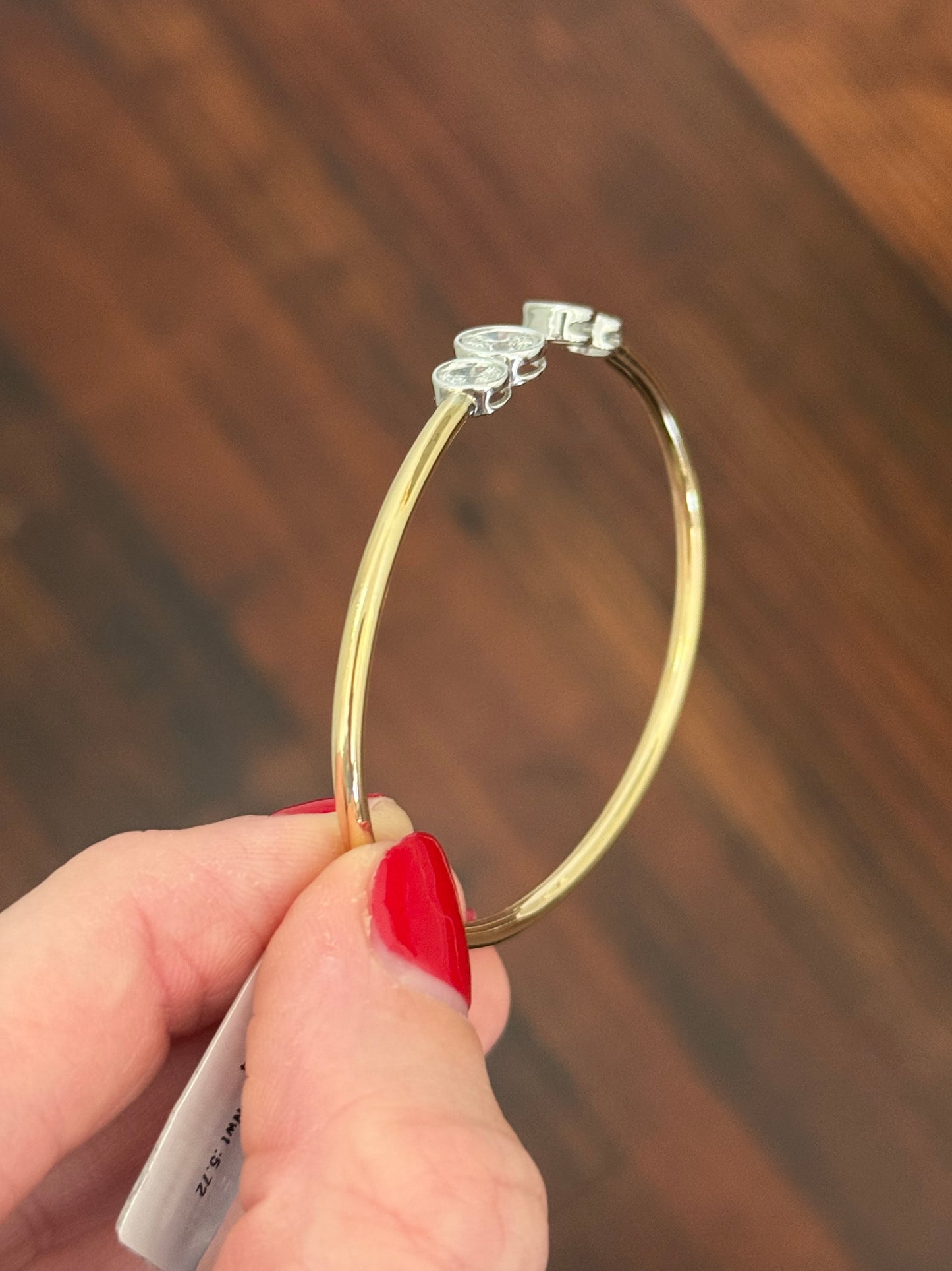 Yellow gold oval lab diamond bracelet. Lab diamond are bezel set in white gold