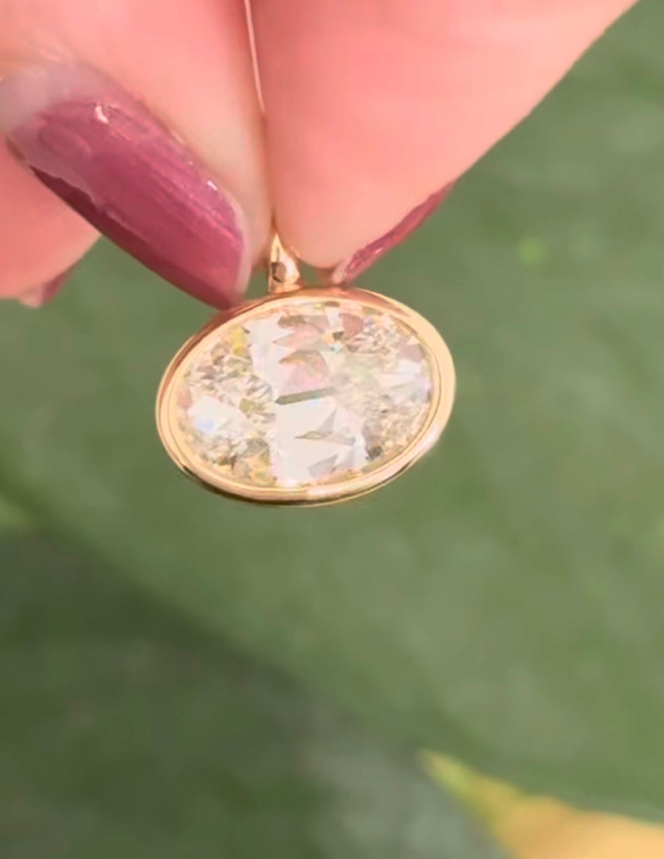 Yellow gold bezel and east west set 3.10ct antique oval cut lab diamond pendant