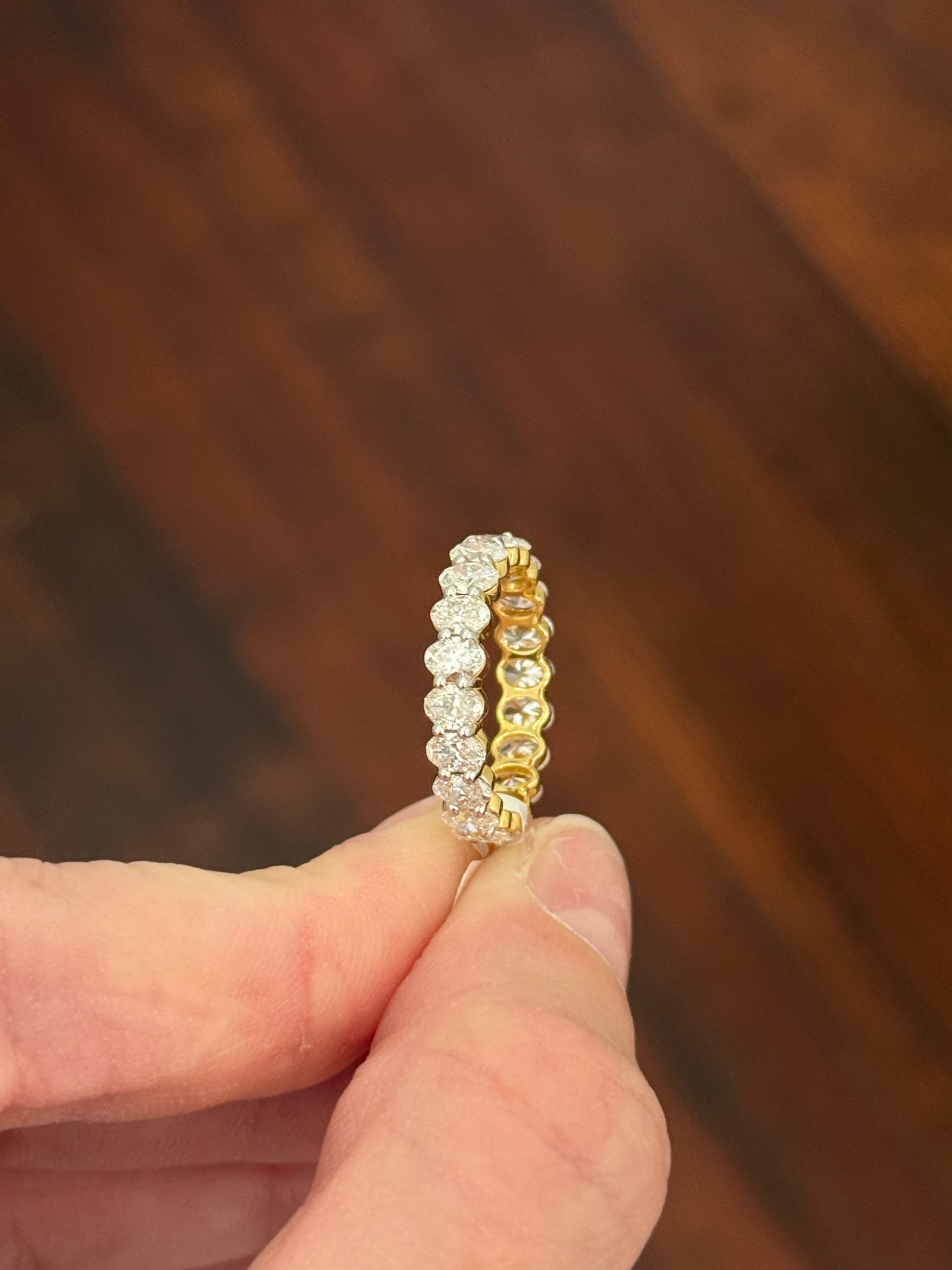 Yellow gold 3.02ct oval lab diamond eternity band. Prongs are white gold.